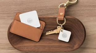 Keys and wallet on desk with tile trackers